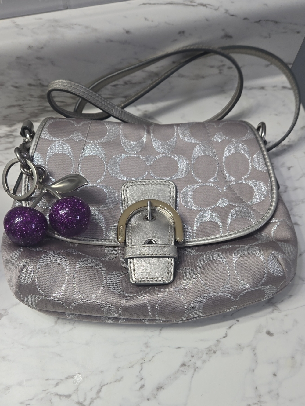 Coach Soho Silver Signature Crossbody with Purple Charm Accent.